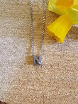 initials letter N met Zirkonia Joy de la Luz